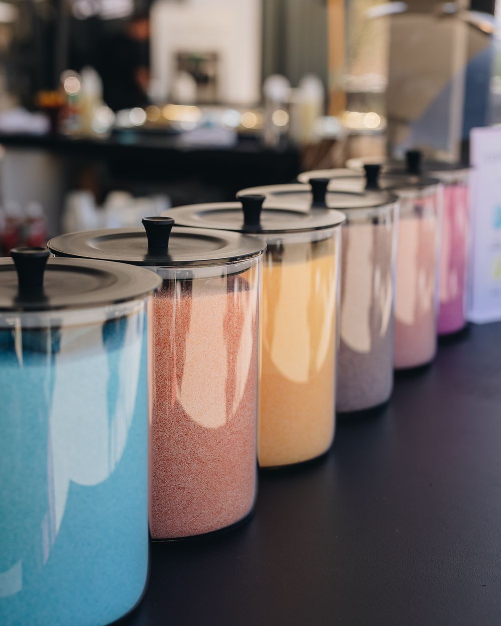 Apothecary jars of blue, pink, orange and purple cotton candy sugar