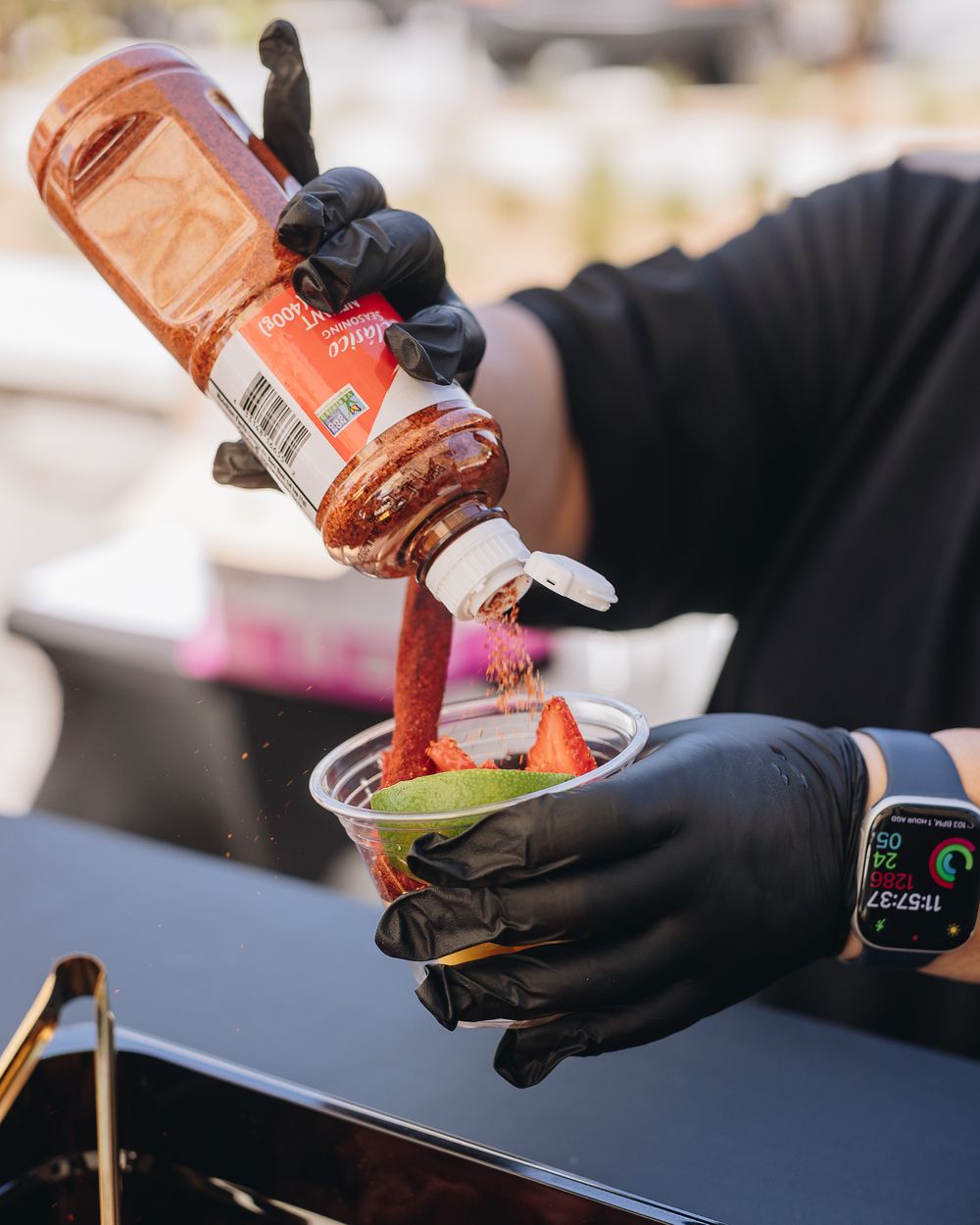 Chamoy drizzled over a cup of fresh fruit